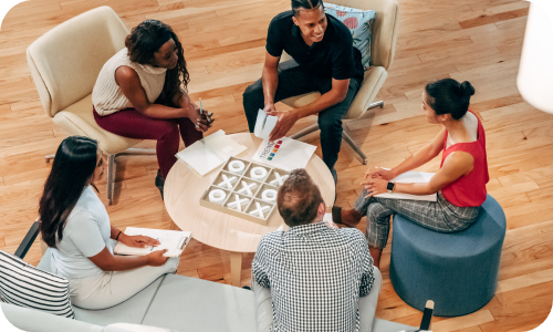 Group of people sitting around a table working collaboratively
